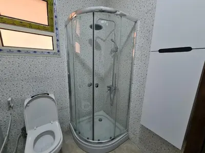 a shower in a bathroom with a toilet at Golden Home Hurghada in Hurghada