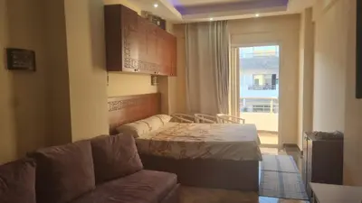 a room with a couch and a bed and a window at Cecelia Resort Hurghada in Hurghada