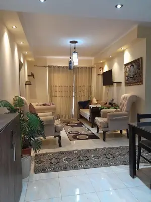 a living room with a couch and chairs and a tv at blue sky florenza in Hurghada
