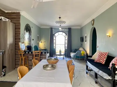 a living room with a table and a couch at Glenholme Country House in ‘Ezbet Abu Ḥabashi