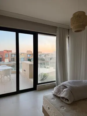 a bedroom with a bed and a view of a balcony at Tawila villa 14 in Hurghada