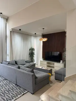 a living room with a couch and a television at Tawila villa 14 in Hurghada