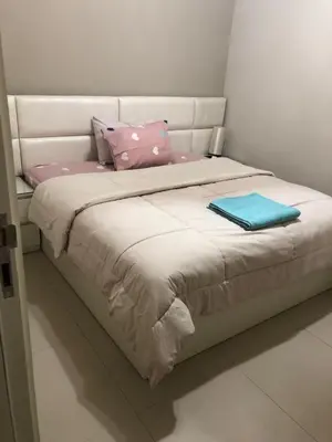 a bed with pink and blue pillows on it at Tawila villa 14 in Hurghada