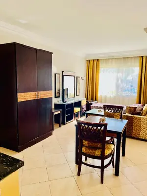 a living room with a table and a couch at Stylish & Cozy 50 m2 Studio Chalet in the Sunset Pearl Apartments in Hurghada