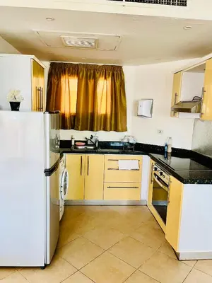 a kitchen with a refrigerator and a sink at Stylish & Cozy 50 m2 Studio Chalet in the Sunset Pearl Apartments in Hurghada