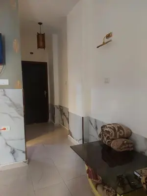 a living room with a couch and a mirror at Luxury Studio in Hurghada