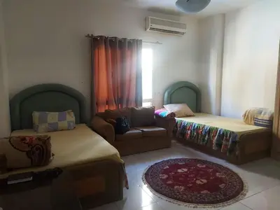 a living room with two beds and a couch at Luxury Studio in Hurghada
