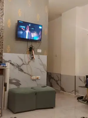 a living room with a tv on a wall at Luxury Studio in Hurghada