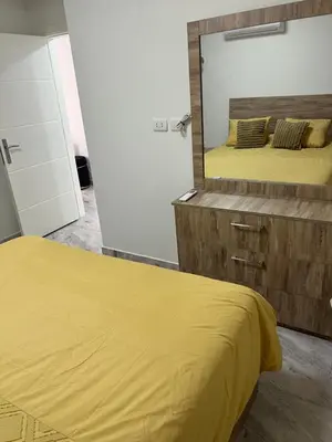 a bedroom with a yellow bed and a mirror at Selena bay hurghada in Hurghada