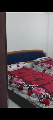 a bed with a bedspread with roses on it at Casablanca resort hi in Hurghada