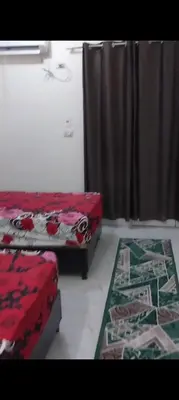 a bedroom with two beds and a rug at Casablanca resort hi in Hurghada