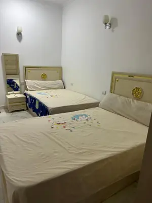 two beds in a room with flowers on the sheets at Red Sea view in Hurghada