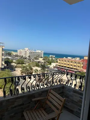a balcony with a bench and a view of the ocean at Red Sea view in Hurghada