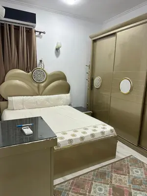 a bedroom with a large bed and a table at Red Sea view in Hurghada