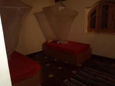 a room with two beds and a window at Shifaya House in Aswan