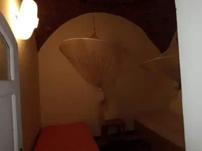 a room with two lamps and a bed and a window at Shifaya House in Aswan