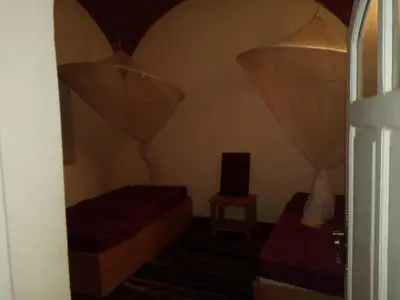 a small room with two beds and a window at Shifaya House in Aswan