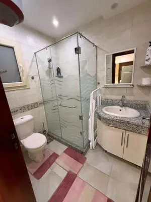 a bathroom with a shower and a toilet and a sink at AL Andalusia Hurghada in Hurghada