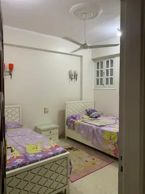 a bedroom with two beds and a ceiling at Luxor is adorable! in Luxor