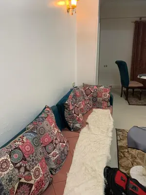 a couch covered in pillows in a living room at Luxor is adorable! in Luxor