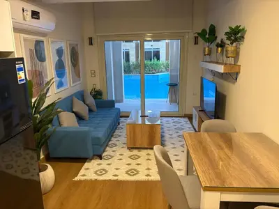 a living room with a blue couch and a table at Duplex in Edelma Oldtown Sahl Hasheesh in Hurghada