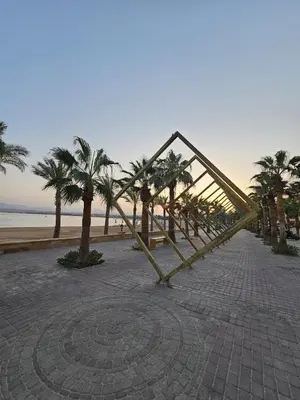 a metal structure on a beach with palm trees at Duplex in Edelma Oldtown Sahl Hasheesh in Hurghada