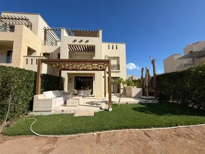 a large white house with a patio in front of it at Cyan Elegant 3BR Golf View Escape in Hurghada