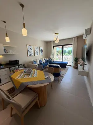 a living room with a couch and a table at Cyan Elegant 3BR Golf View Escape in Hurghada