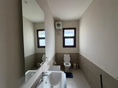 a bathroom with a sink and a toilet at Cyan Elegant 3BR Golf View Escape in Hurghada