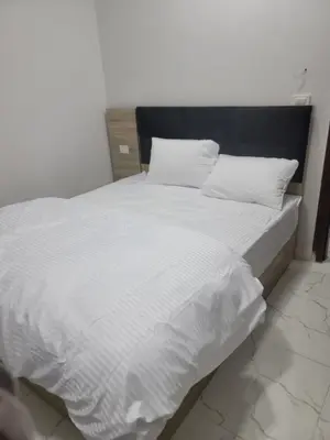 a large white bed with white sheets and pillows at st george in Hurghada