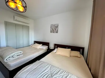 two beds sitting next to each other in a room at Swan Lake 3BR with Roof & Terrace in Hurghada