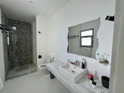 a white bathroom with a sink and a shower at Swan Lake 3BR with Roof & Terrace in Hurghada