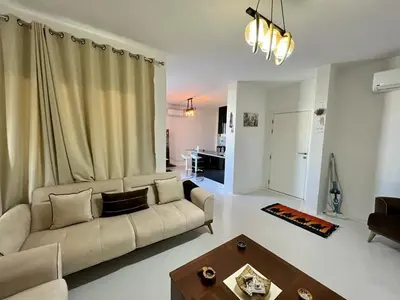 a living room with a couch and a table at Swan Lake 3BR with Roof & Terrace in Hurghada