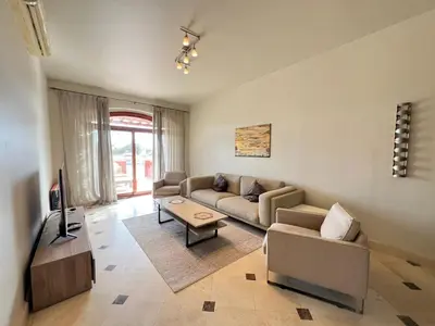a living room with a couch and a tv at Lagoon-Front 3BR Townhouse in Upper Nubia in Hurghada