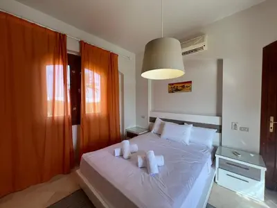 a bedroom with a bed with two towels on it at Lagoon-Front 3BR Townhouse in Upper Nubia in Hurghada