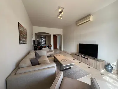 a living room with a couch and a flat screen tv at Lagoon-Front 3BR Townhouse in Upper Nubia in Hurghada