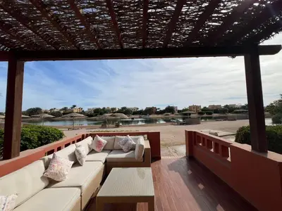 a porch with a couch and a view of the water at Lagoon-Front 3BR Townhouse in Upper Nubia in Hurghada
