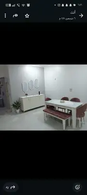 a room with a table and a bench and mirrors at noreno houseاسوان شياخة تانية طريق السادات in Aswan