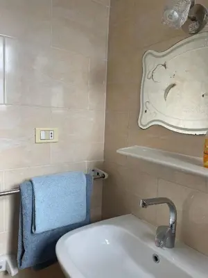 a bathroom with a sink and a blue towel at Paradise at Tiba Al Ahyaa, Hurghada in Hurghada