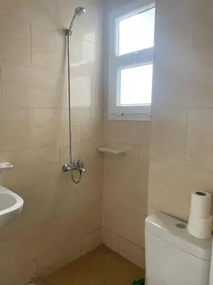 a bathroom with a shower and a toilet and a sink at Paradise at Tiba Al Ahyaa, Hurghada in Hurghada