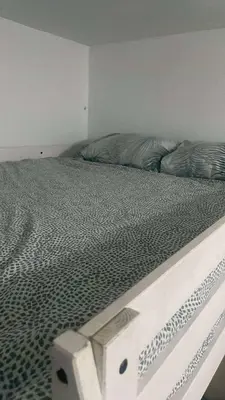 an unmade bed in a white room with at Paradise at Tiba Al Ahyaa, Hurghada in Hurghada
