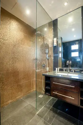 a bathroom with a glass shower and a sink at Private Ali Pasha 2BR Pool Access + Dining Perks in Hurghada