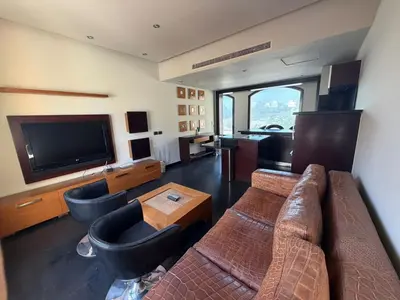 a living room with a couch and a flat screen tv at Private Ali Pasha 2BR Pool Access + Dining Perks in Hurghada
