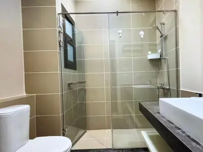 a bathroom with a shower with a toilet and a sink at View and Location in Abu Tig Marina in Hurghada