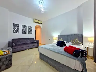 a bedroom with a bed and a couch at Gravity Sahl Hasheesh Not Egyptians in Hurghada