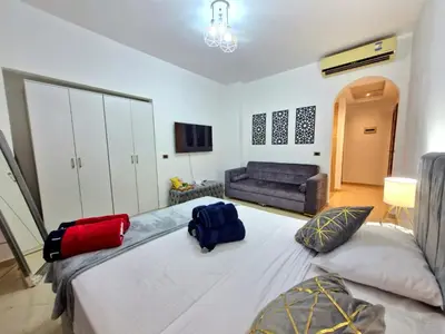 a bedroom with a large bed with two bags on it at Gravity Sahl Hasheesh Not Egyptians in Hurghada