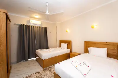 a bedroom with two beds and a window at Villa Ramses in Luxor