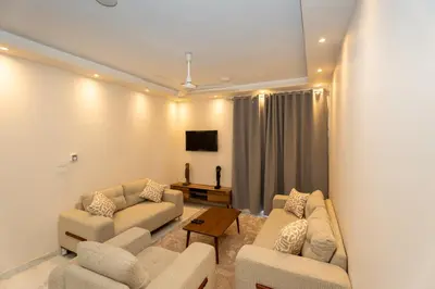 a living room with two couches and a tv at Villa Ramses in Luxor