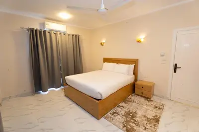 a small bedroom with a bed and a window at Villa Ramses in Luxor
