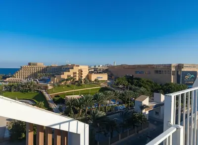 a view of the city from the balcony of a resort at Hurghada stylish Apartment on the beach in Hurghada